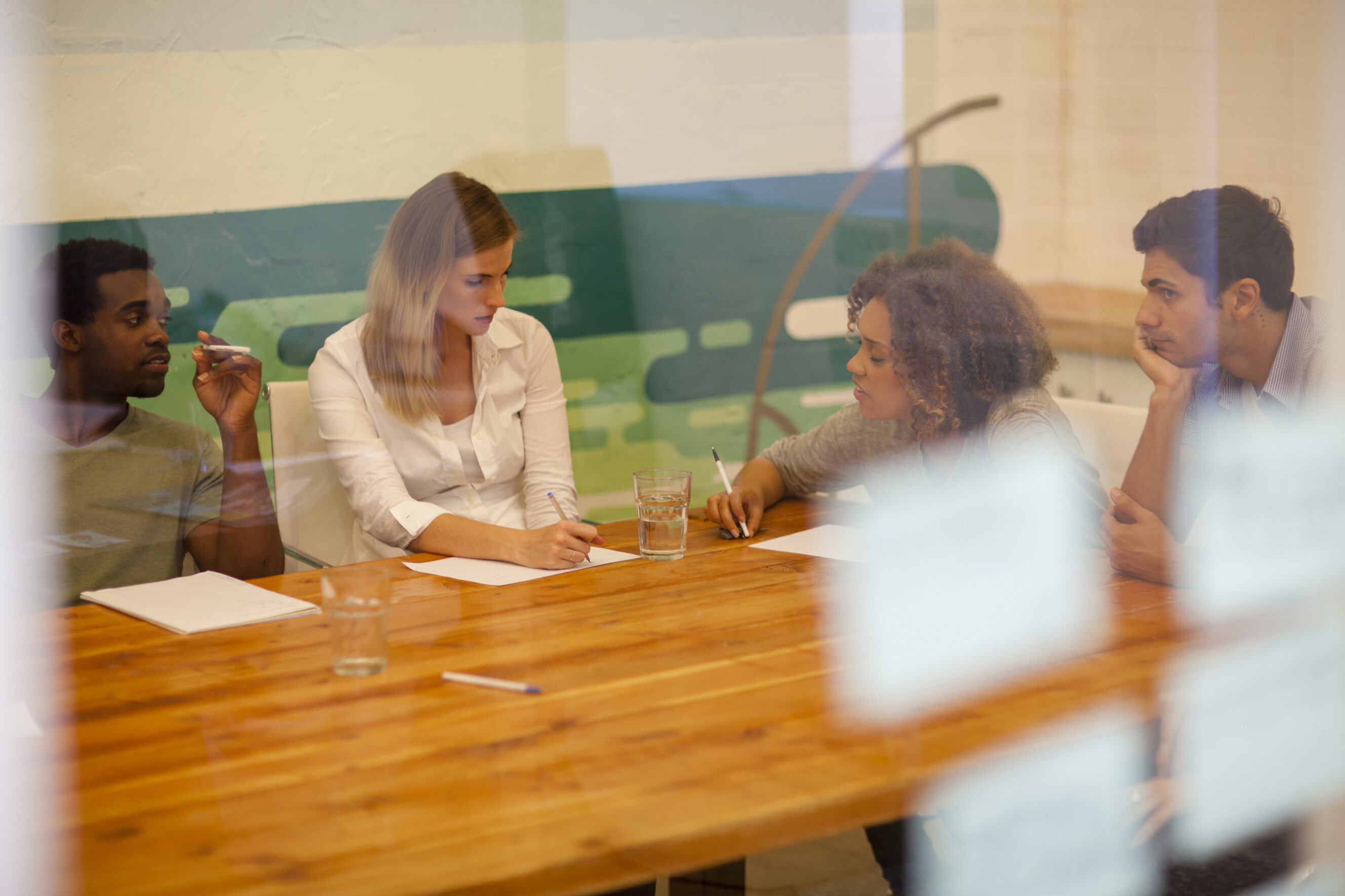 Group of market researchers collaborating in a meeting room, highlighting professional market research services near you.