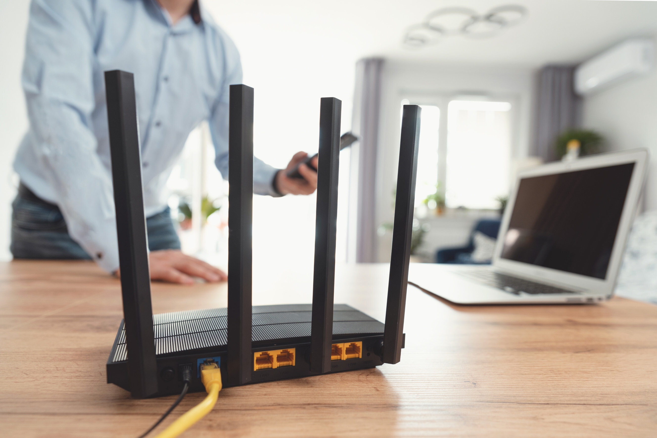 Experienced technician setting up a router and modem in a home office, highlighting highly rated router and modem setup services near you.