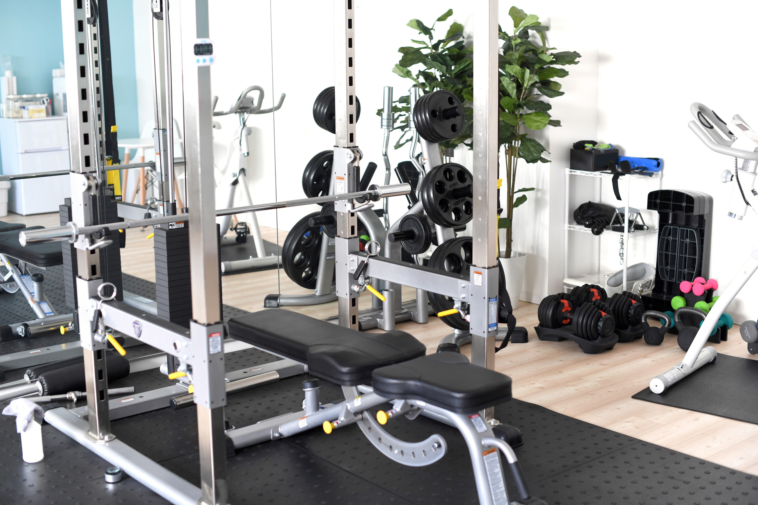 Expert assembling a home gym setup with weights and a bench, highlighting professional home gym assembly experts near you.