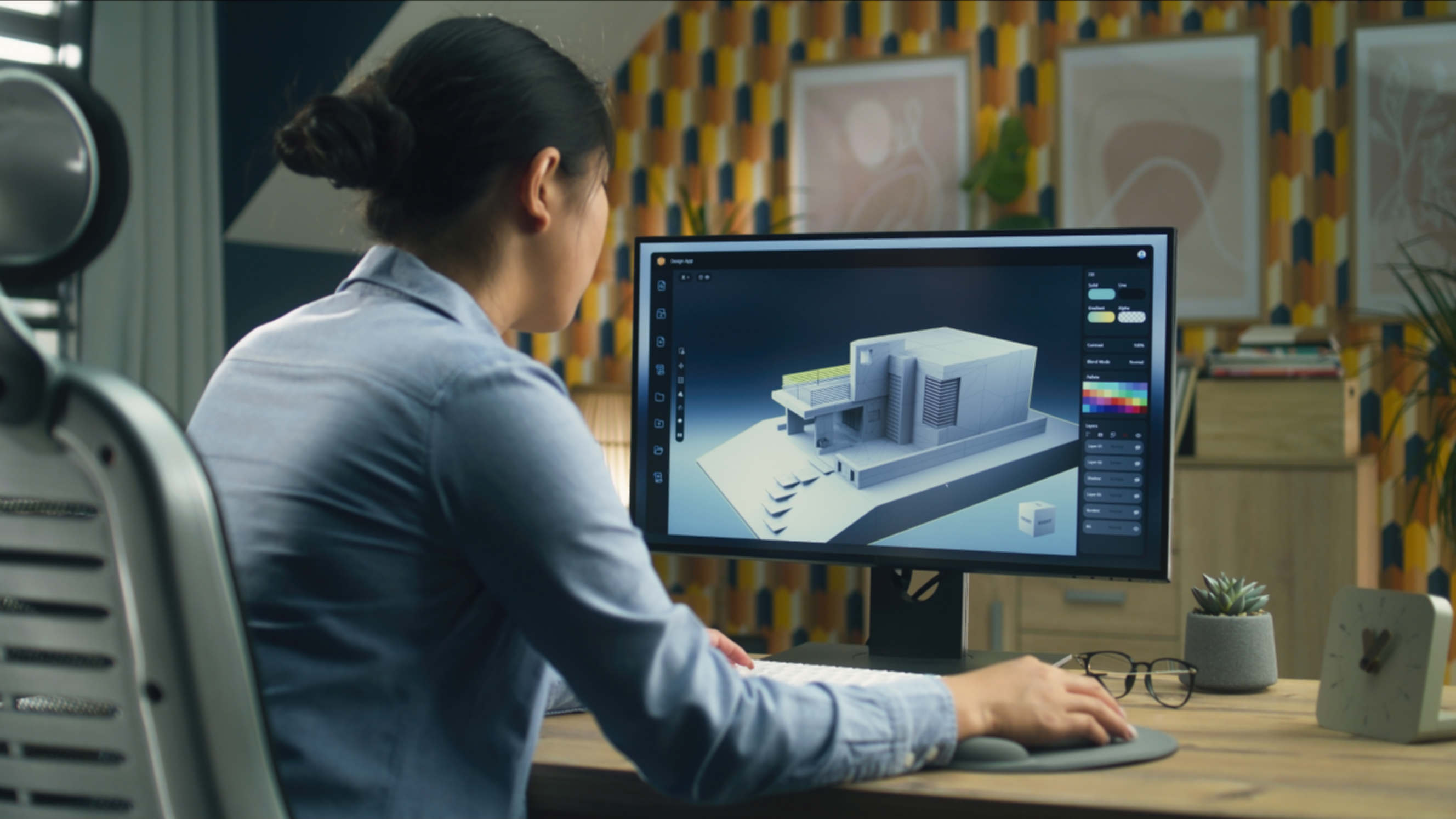 Architect designing a 3D building model on a computer screen in a home office.