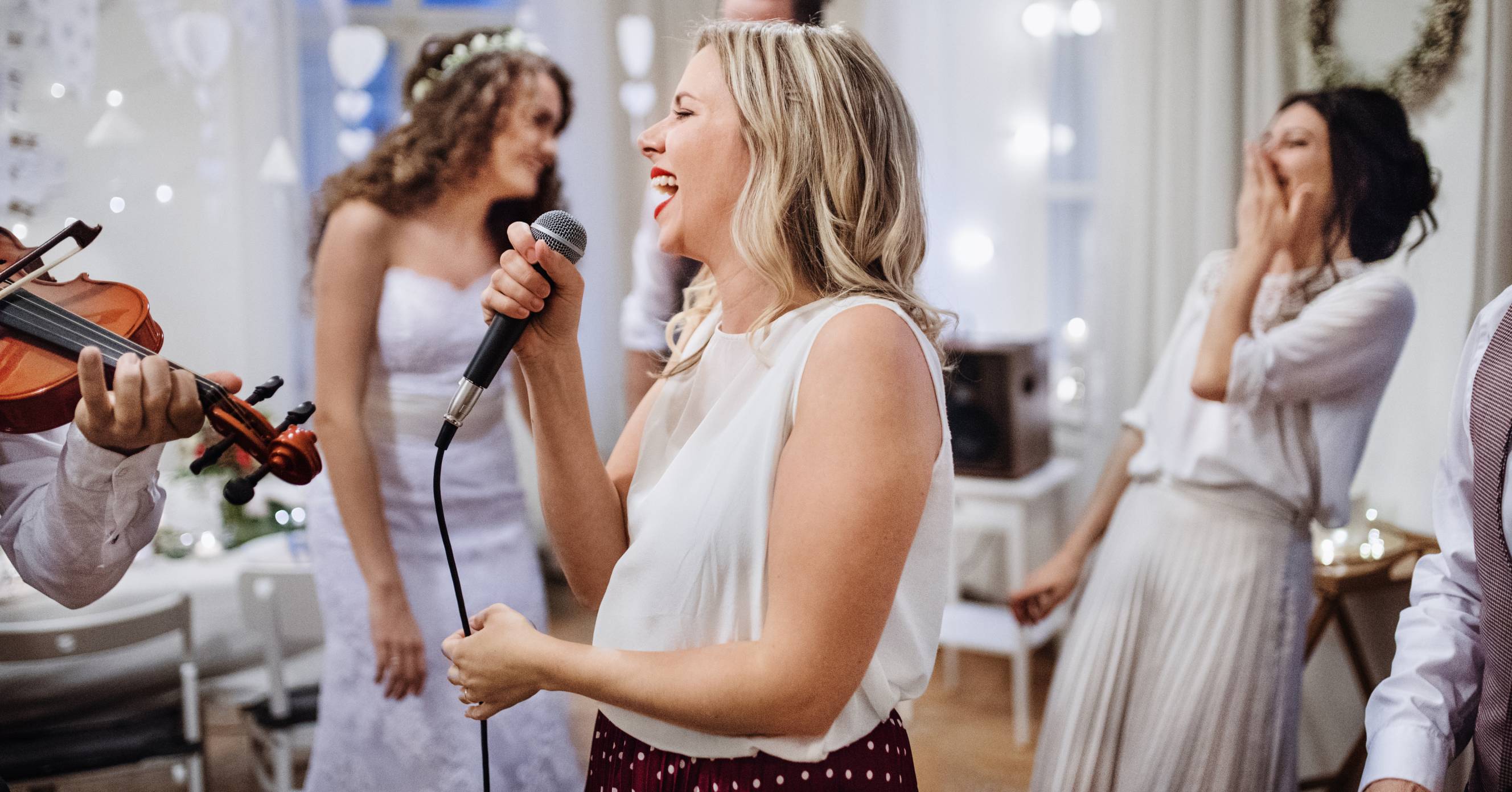 A young woman performing as a wedding singer for hire at the reception