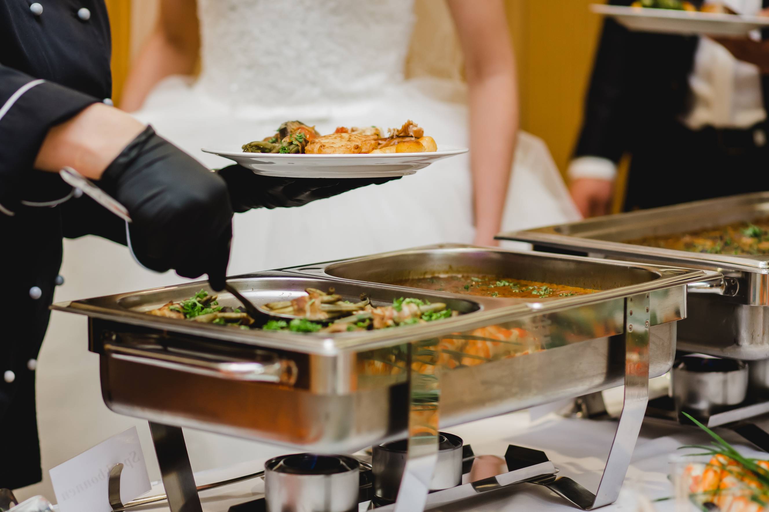 A wedding caterer near me serving food during the wedding reception