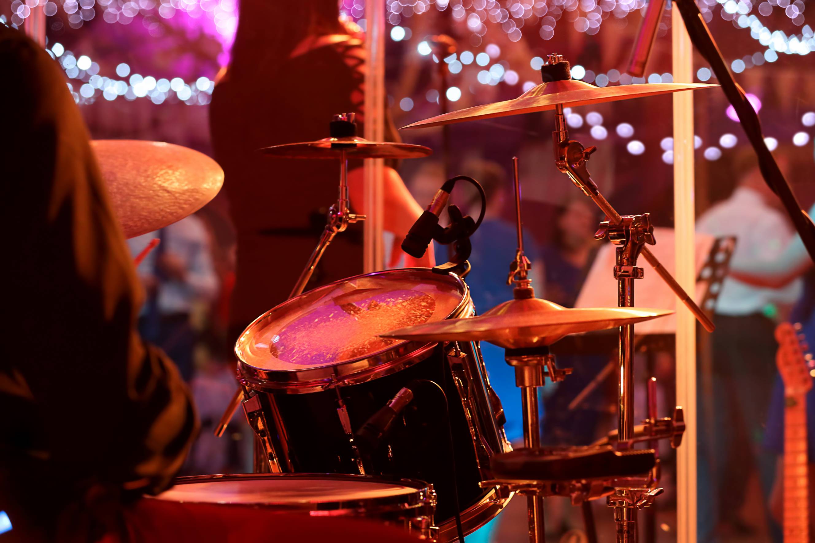 A drummer performing during the reception as part of a wedding band for hire near me