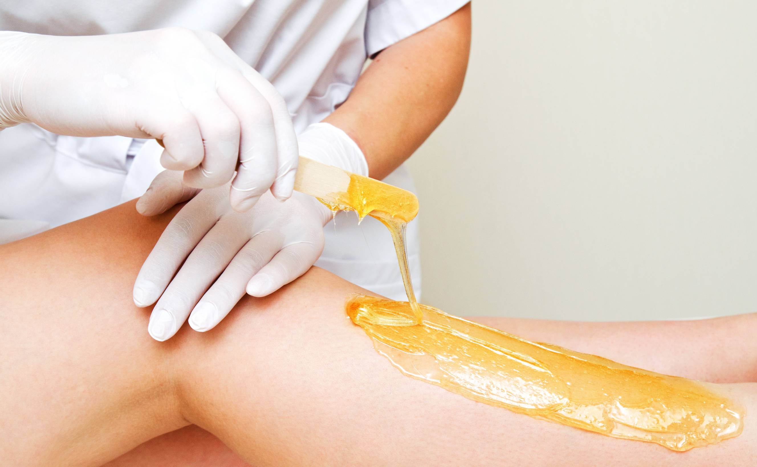 A professional performing a waxing service near me for a client