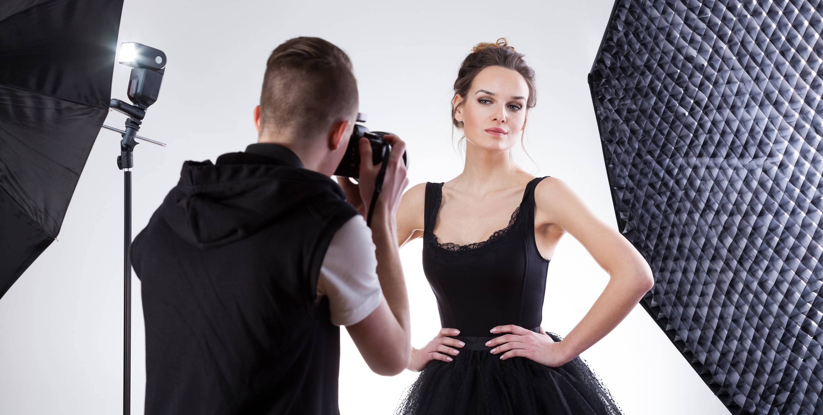 A fashion photographer near me doing a fashion photoshoot with a woman in a black dress