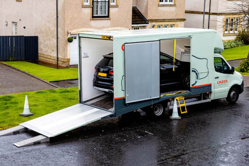 Car transport cost - A single car being delivered in an enclosed transport truck