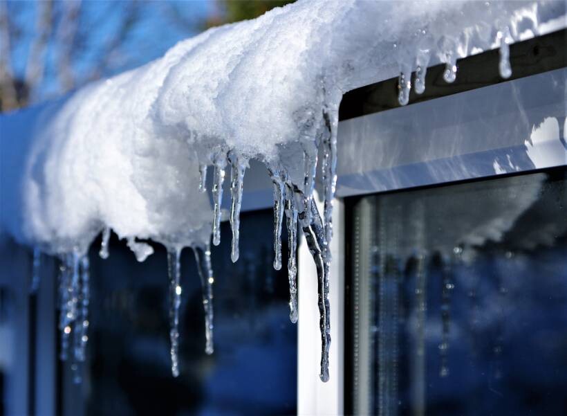 gutter cleaning cost - gutter covered in ice during winter