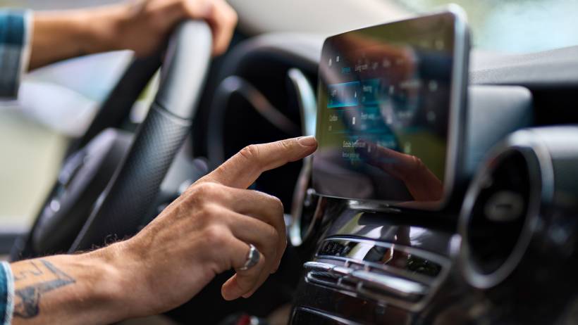 Driver using a touchscreen display in a modern car interior - earn money running errands