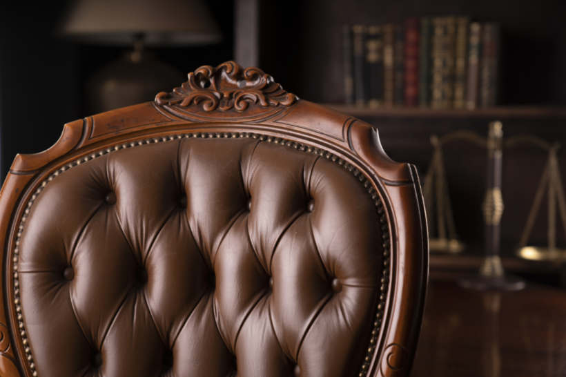 Cost to reupholster a chair - Close-up of a tufted brown leather chair