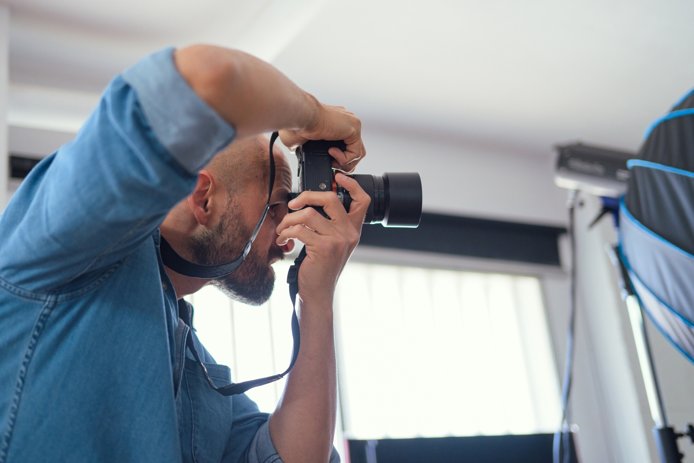  A photographer prepares to shoot in a studio, where lighting and camera settings impact grayscale and monochrome results.