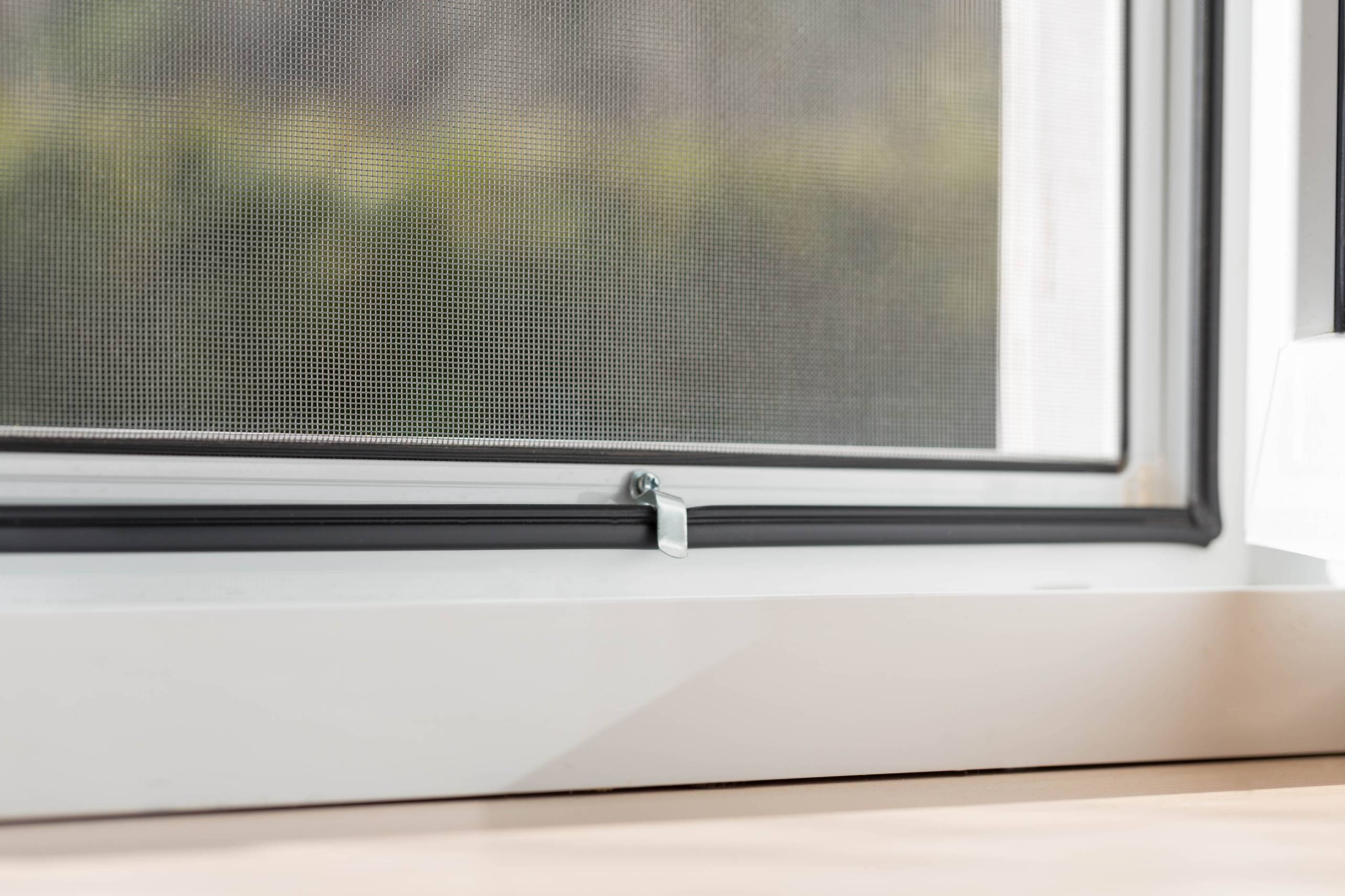 Close-up of a mesh flyscreen installed on a modern window frame