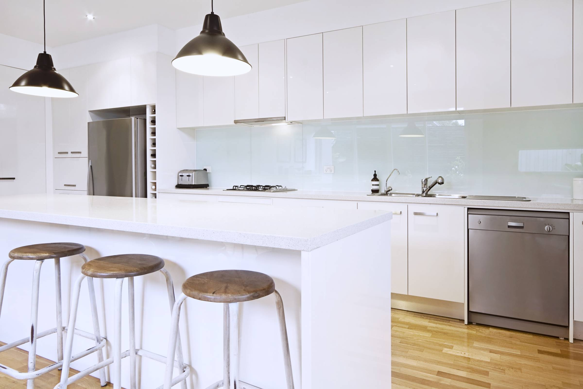 a modern kitchen with a glass splashback