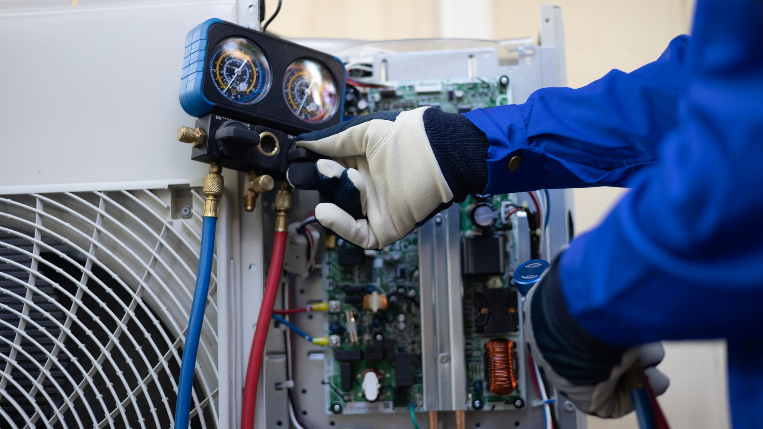 Close-up Air conditioner technician hand checks the refrigerant liquid and maintains of the condenser unit, symbolizing sub-zero fridge repair near me.