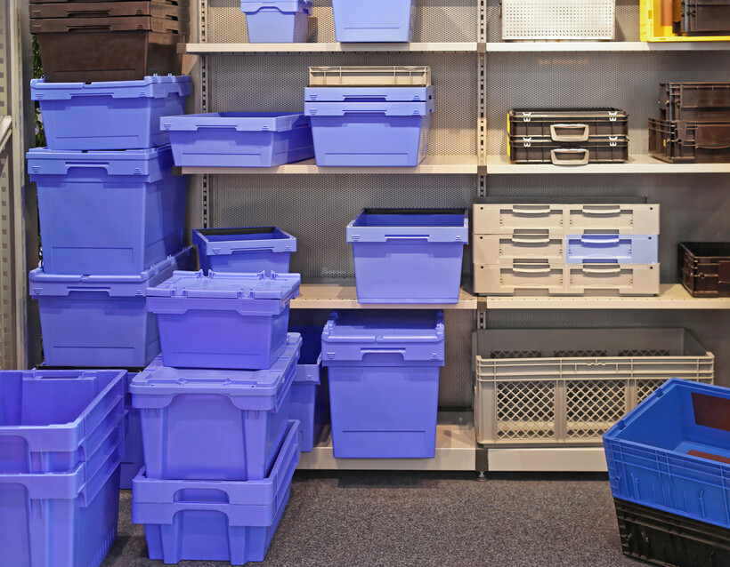 Assorted plastic bins organised on metal shelving.- plastic bins vs cardboard boxes