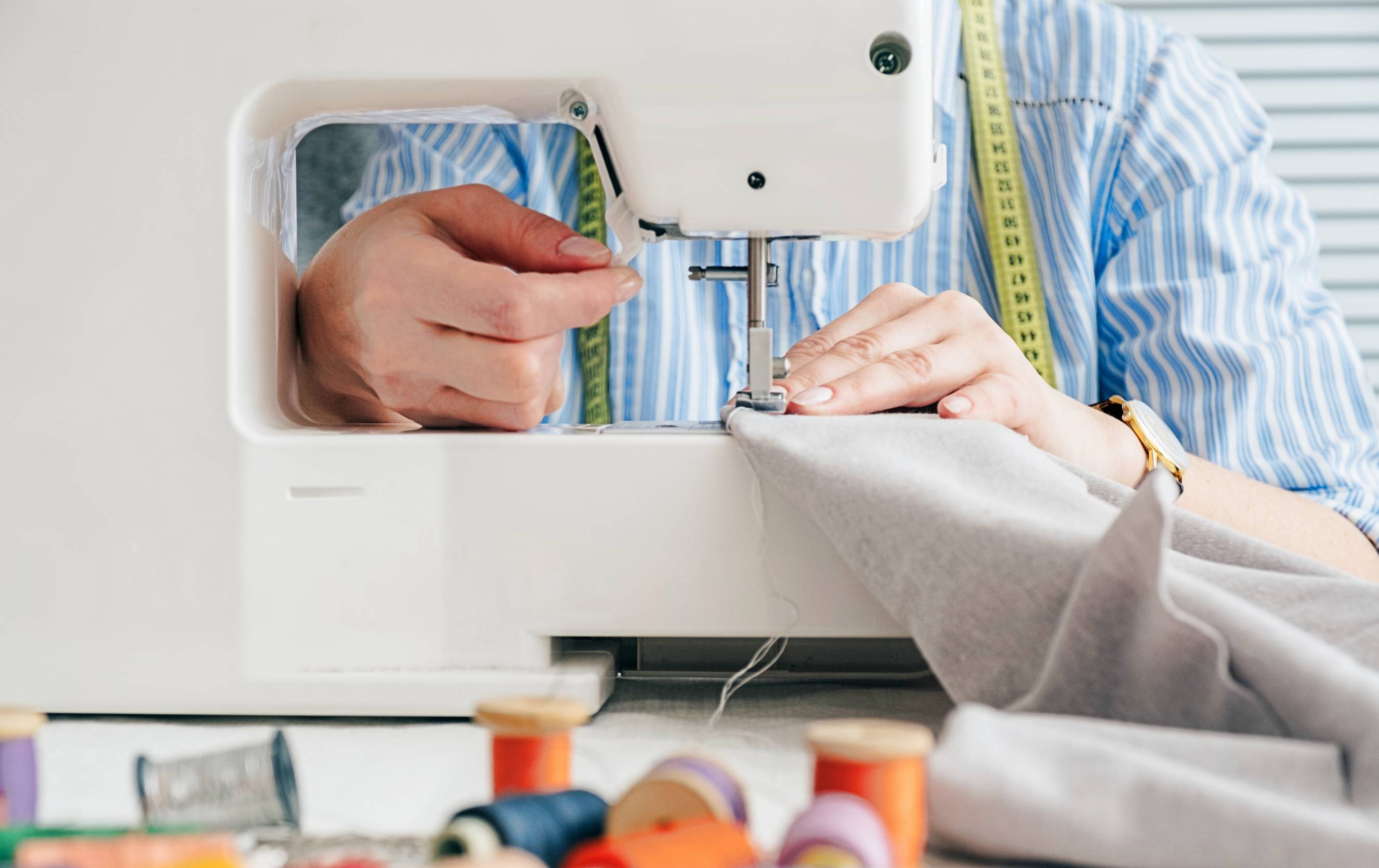 a person using a sewing machine at work