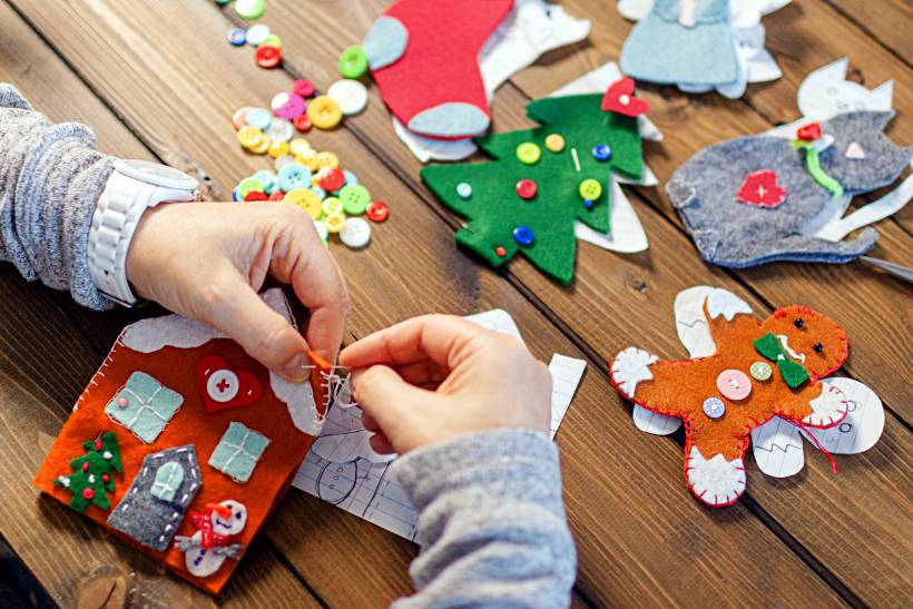 how to make money sewing - DIY holiday decorations in progress, including felt trees, stockings, and a gingerbread man