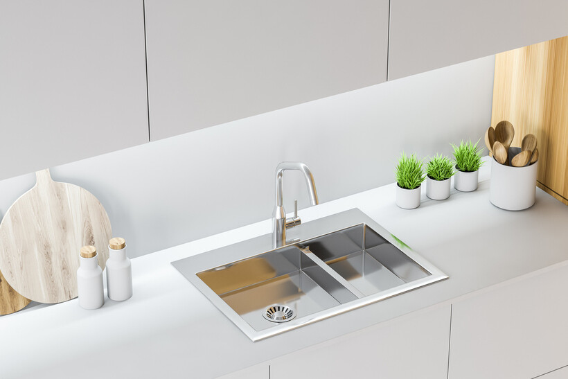 Modern kitchen with a stainless steel double sink and minimalist decor. - basin vs sink