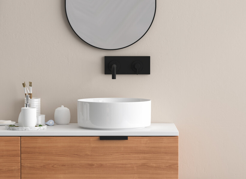 Modern bathroom vanity with a white vessel basin and round mirror. - basin vs sink