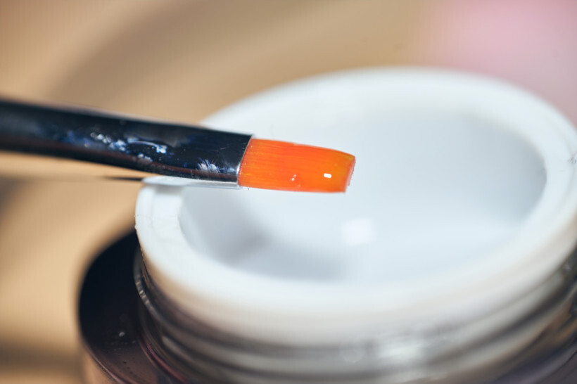 hard gel vs builder gel - a close-up of a brush dipped in clear builder gel before application