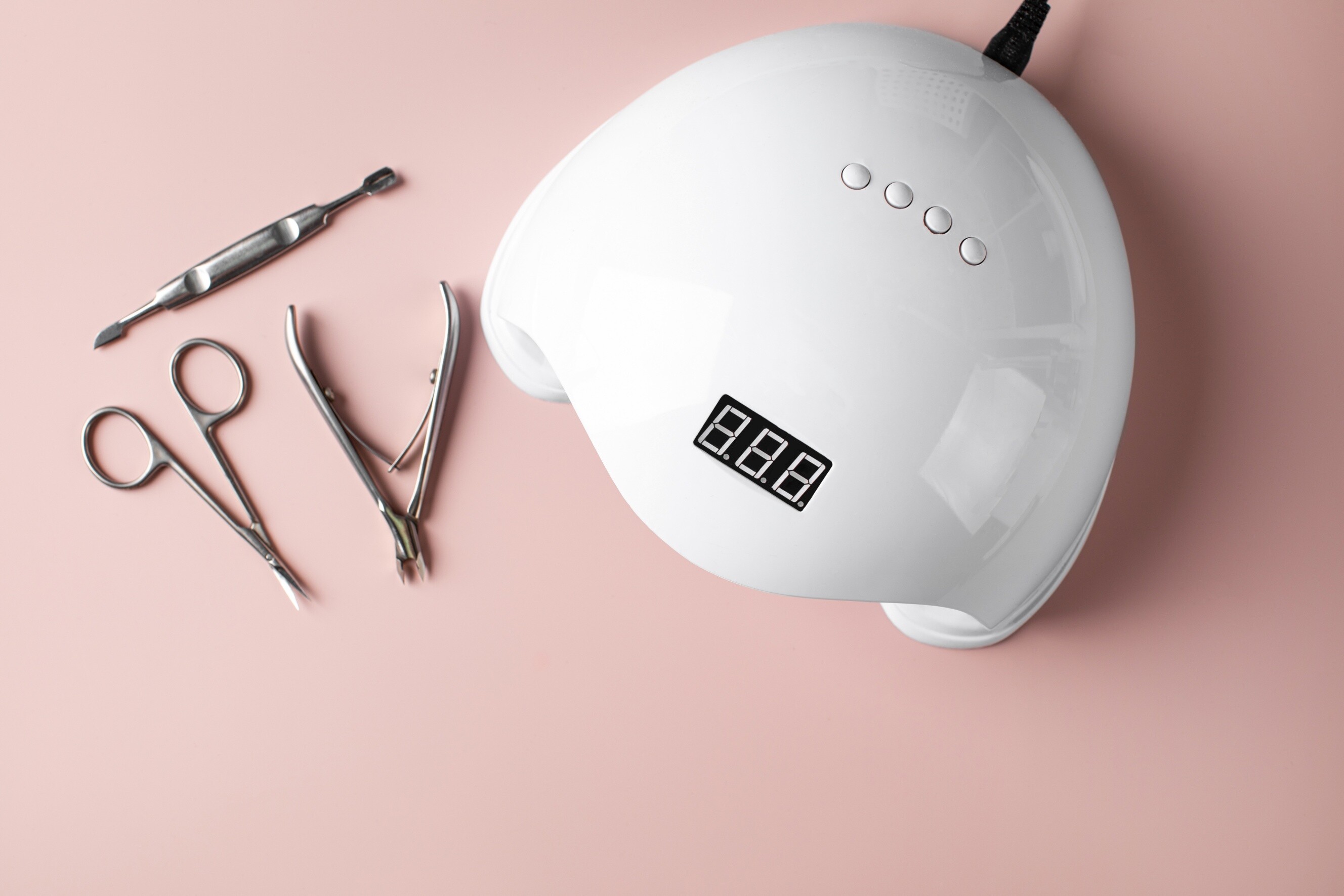 Essential manicure tools with a UV LED gel nail lamp.
