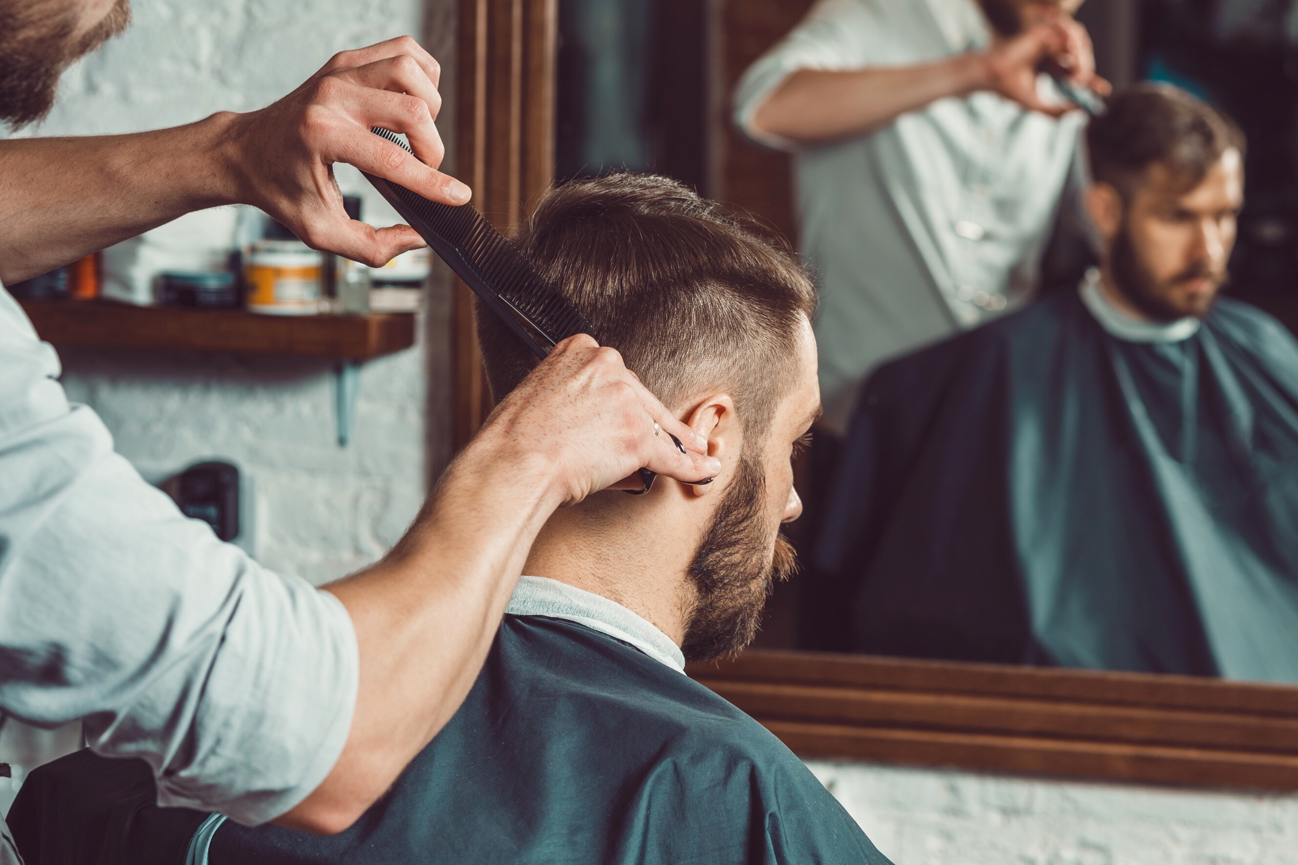 Precision trimming by a hairdresser for a clean and professional look.