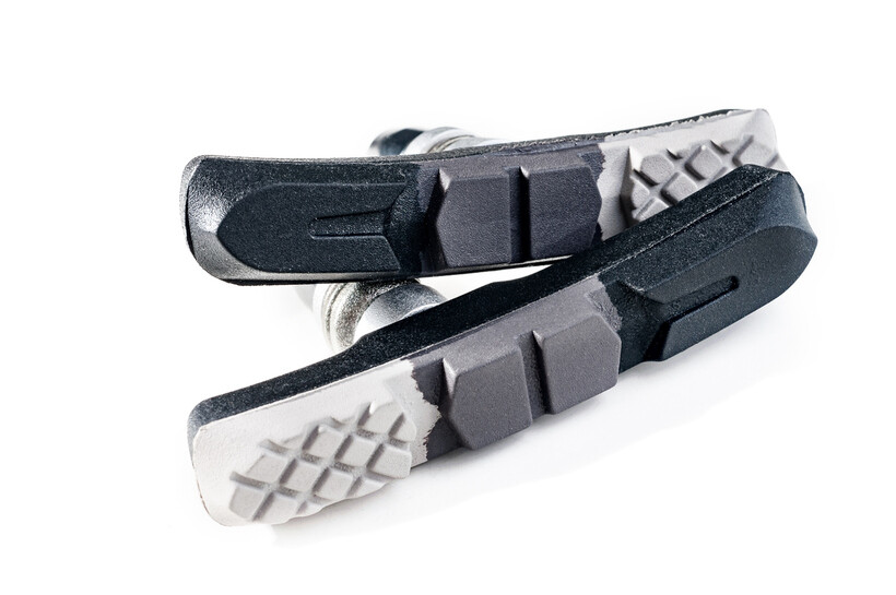 Pair of bicycle organic brake pads with a textured surface. - organic vs sintered brake pads
