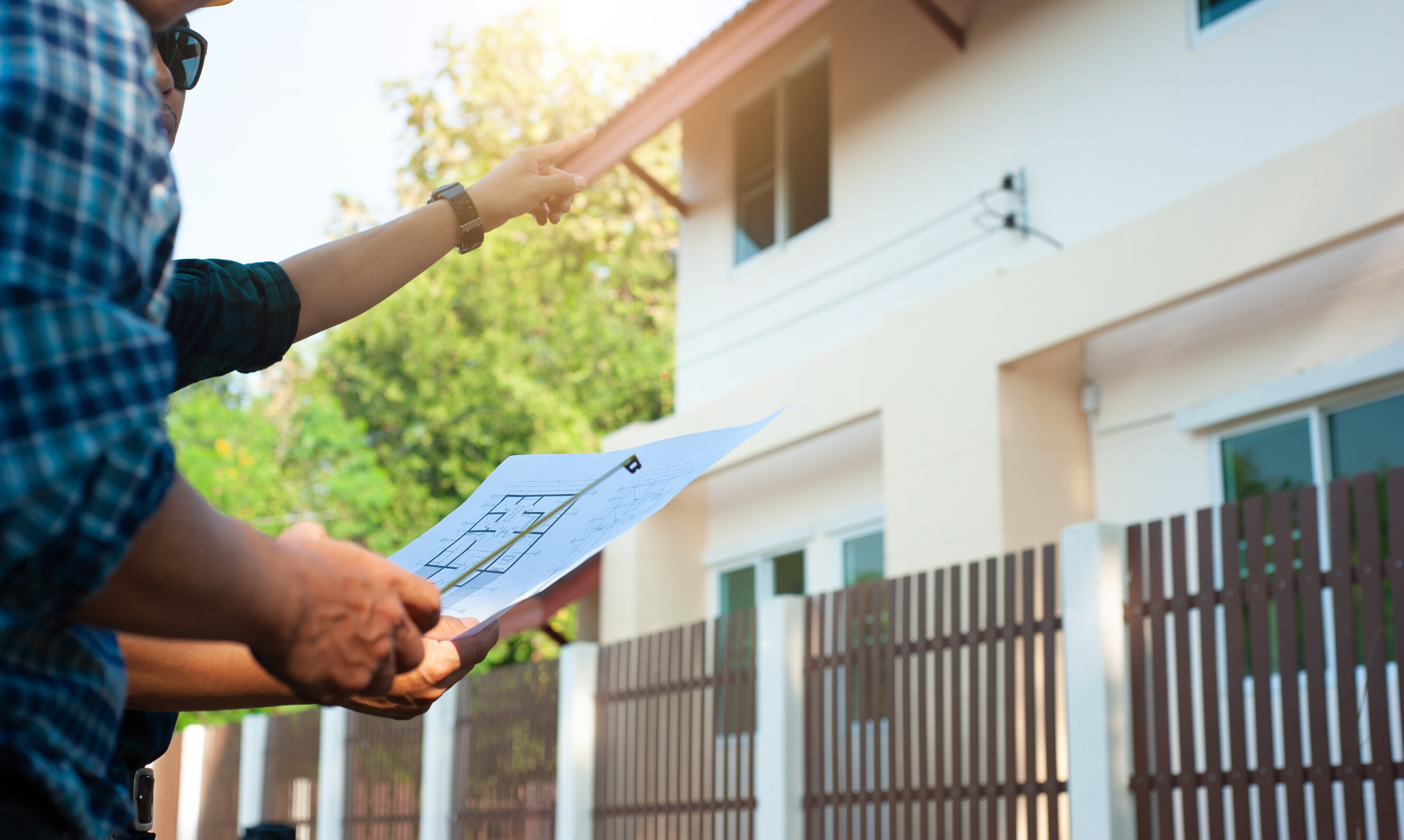 Two people reviewing house blueprints before renovation.