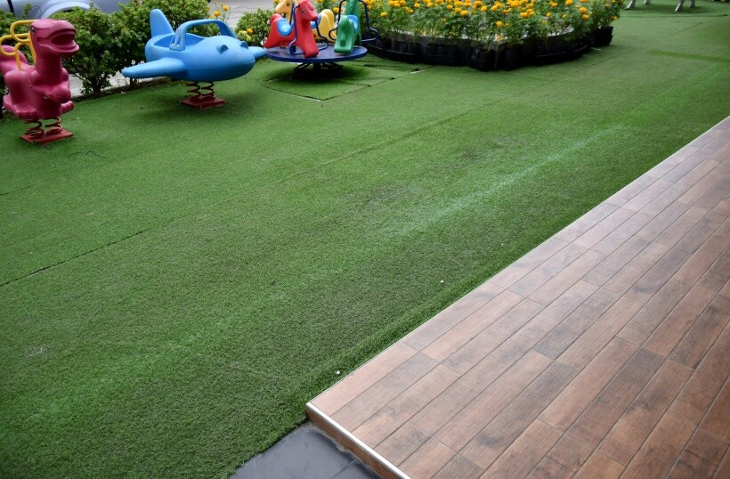  turf vs grass - Synthetic turf grass surface installed in a children's play area.