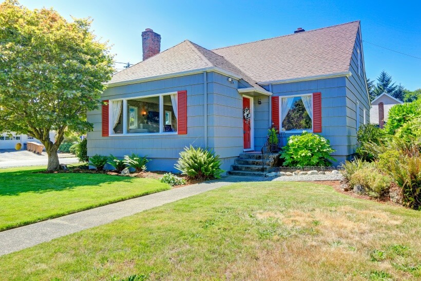  turf vs grass - House exterior with maintained green grass lawn under bright sunlight.