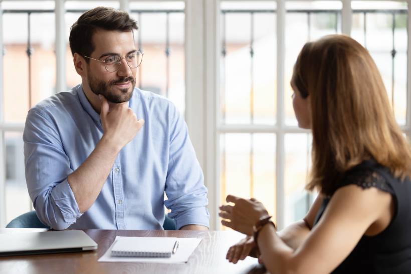 life coach vs career coach - Life coach attentively listening to a client during a one-on-one session