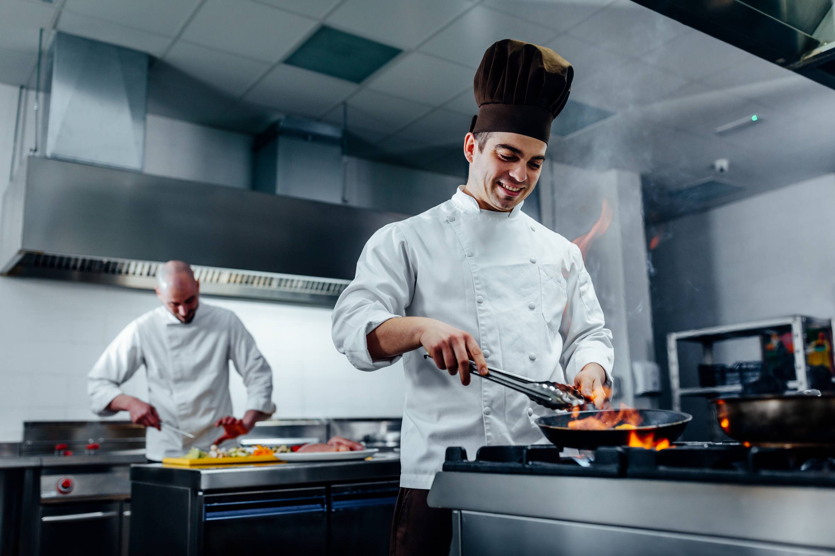 A chef and a cook preparing and cooking food
