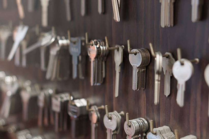 keysmith vs locksmith - Wall-mounted rack filled with various blank keys at a keysmith shop