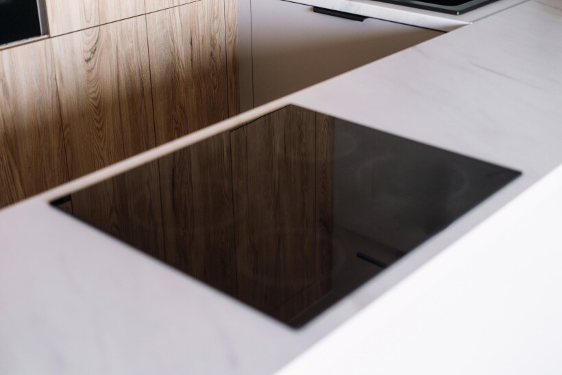 ceramic vs induction cooktop - Unused induction cooktop on a marble countertop.