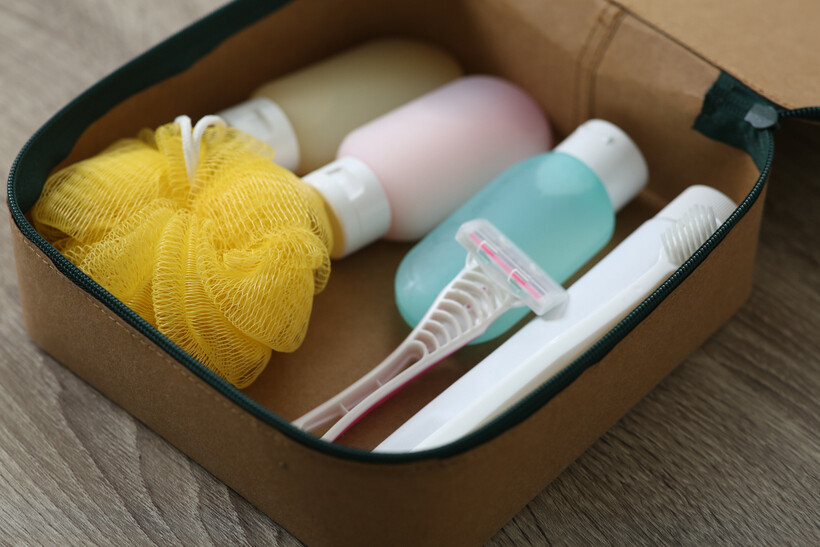 Close-up of an open toiletry bag with hygiene items packed for moving. - last minute moving
