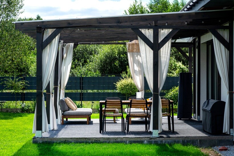 Curtain ideas - Outdoor pergola with white flowing patio panels and patio furniture