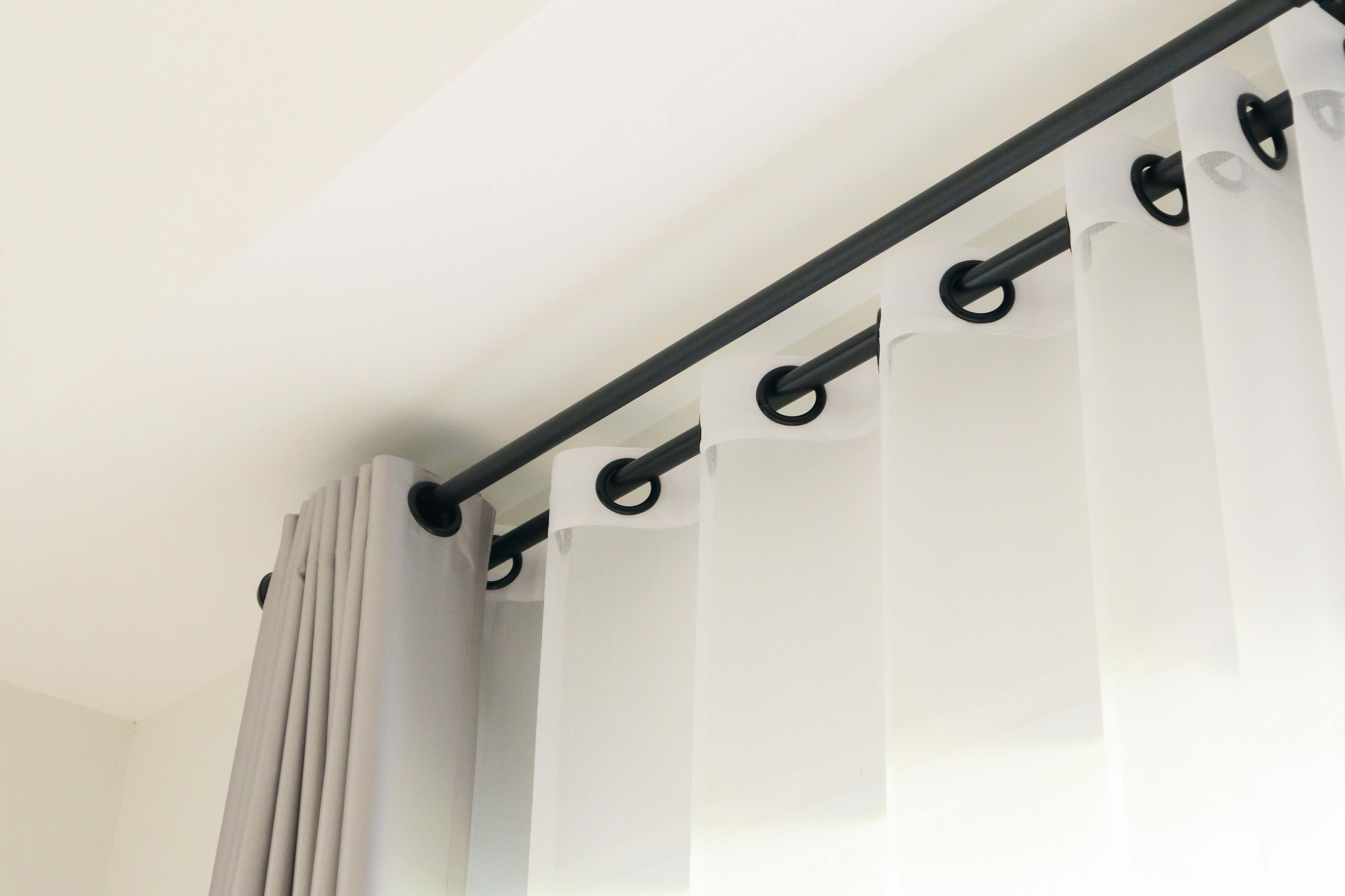 Curtain ideas - Eyelet curtains hanging on a black curtain rod