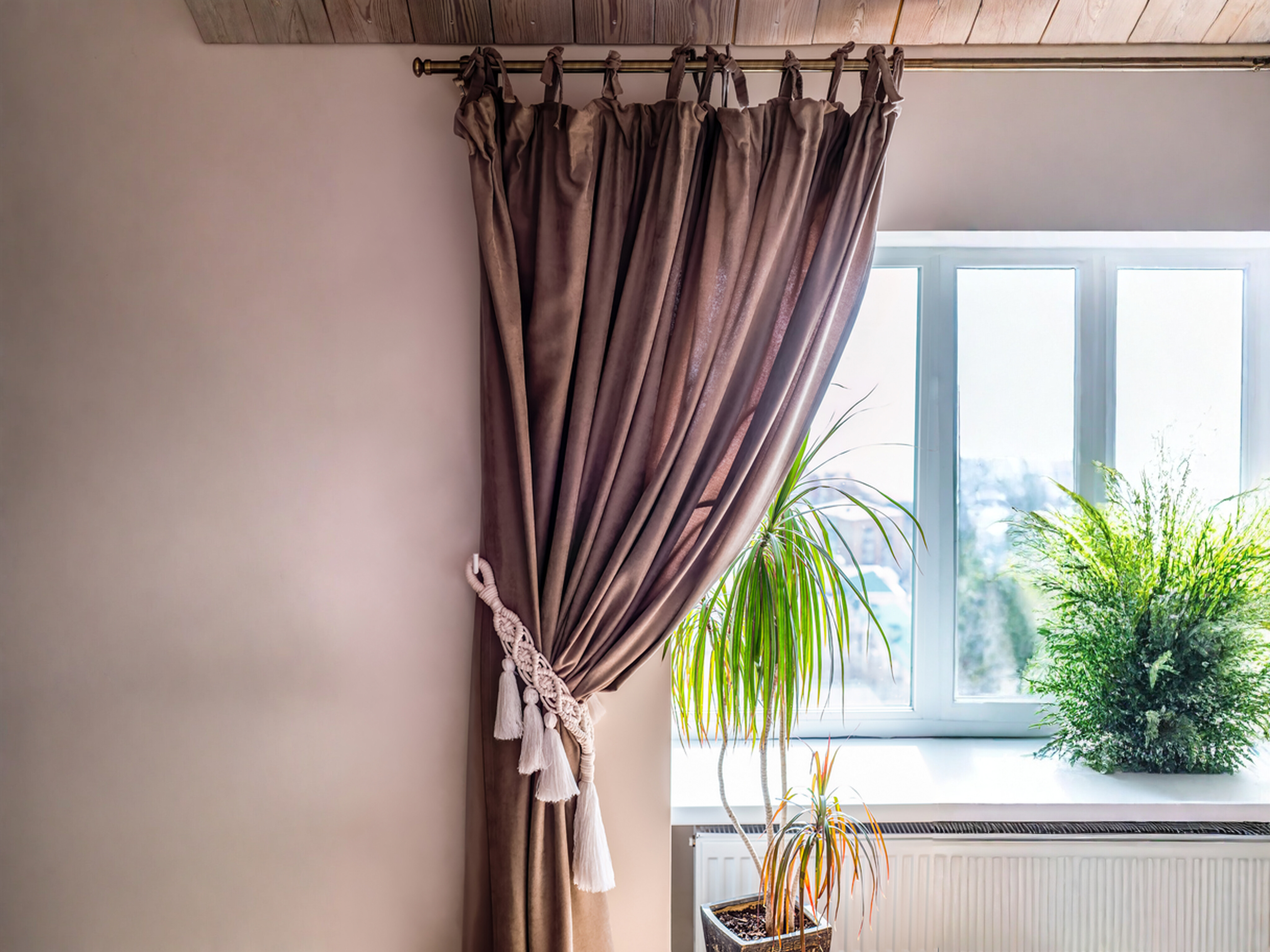 Curtain ideas - Velvet-style tie-top drapes pulled to the side with tassel holdback