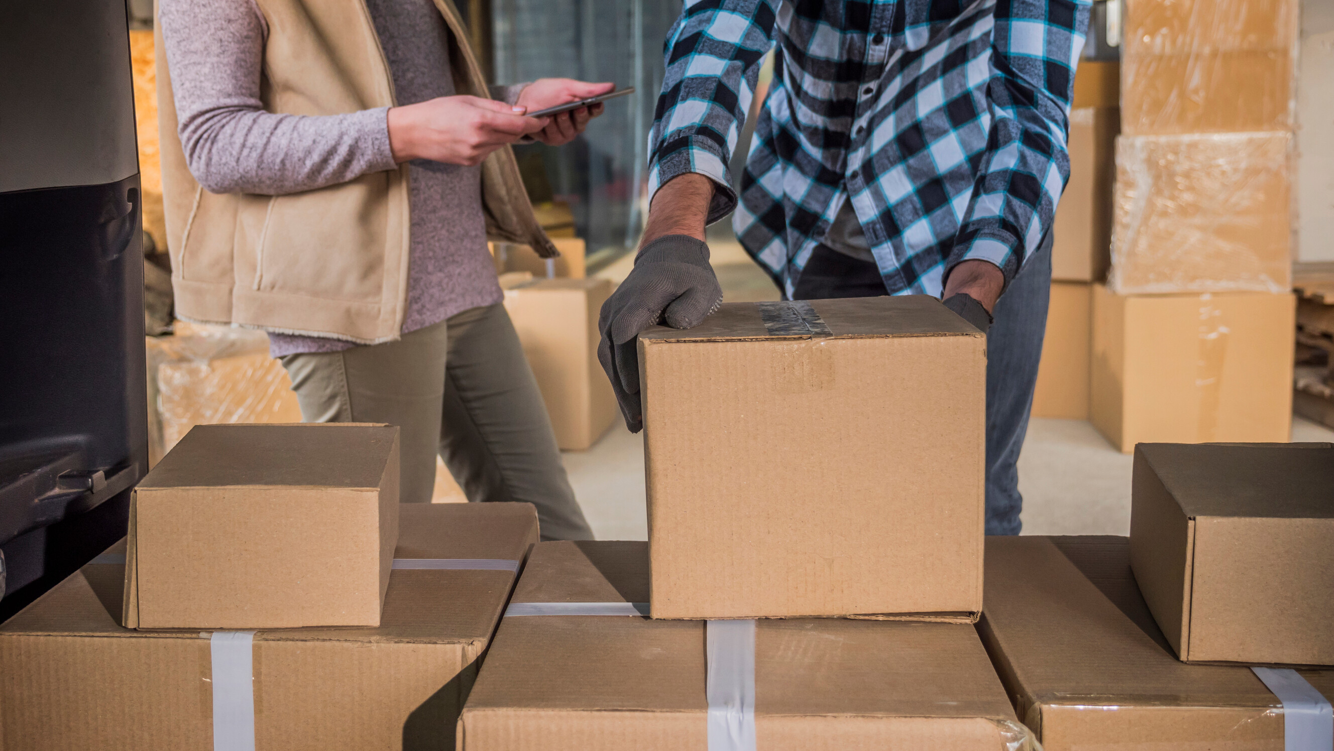 People handling moving tasks with cardboard boxes ahead of relocation.