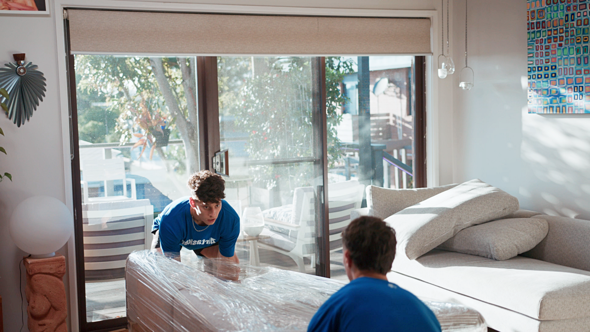 two Taskers lifting a heavy sofa