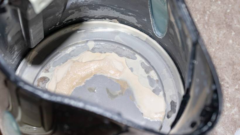Electric kettle interior with heavy white and tan limescale buildup - how to descale kettle
