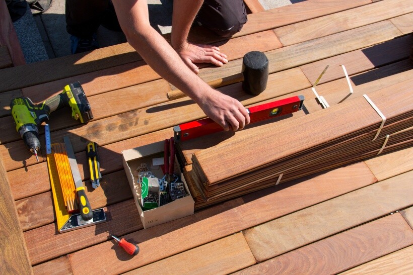 Renovations - Tools and wooden planks arranged for patio renovation