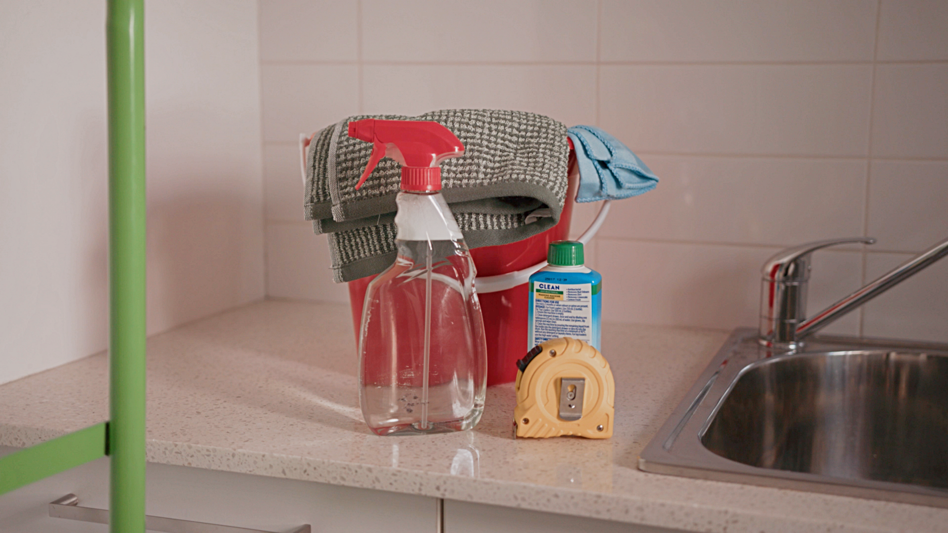 how to move washer and dryer - Red bucket with cloths, spray bottle, and tape measure for preparing appliance move