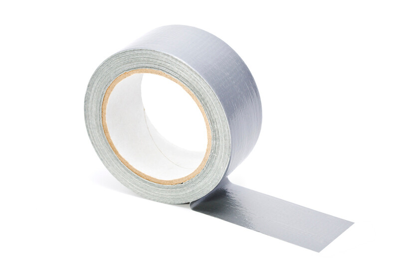 A roll of silver heavy-duty adhesive tape isolated on a white background. - duct tape vs packing tape