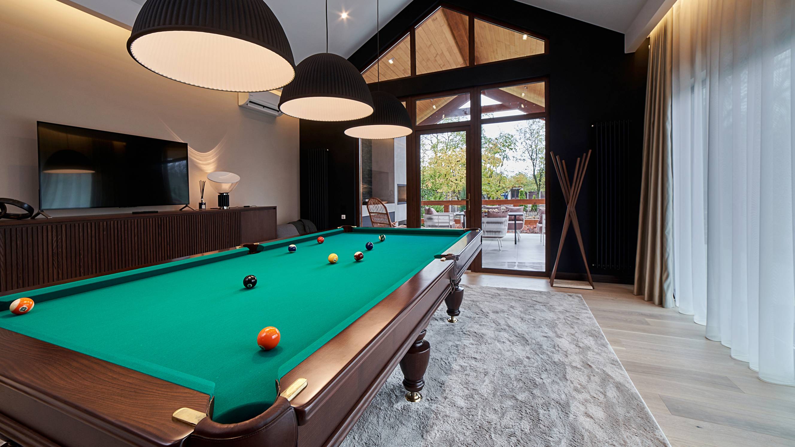 modern pool table room with a beautiful table and large window