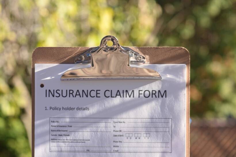 cost to move a pool table - Close-up of an insurance claim form clipped to a board outdoors