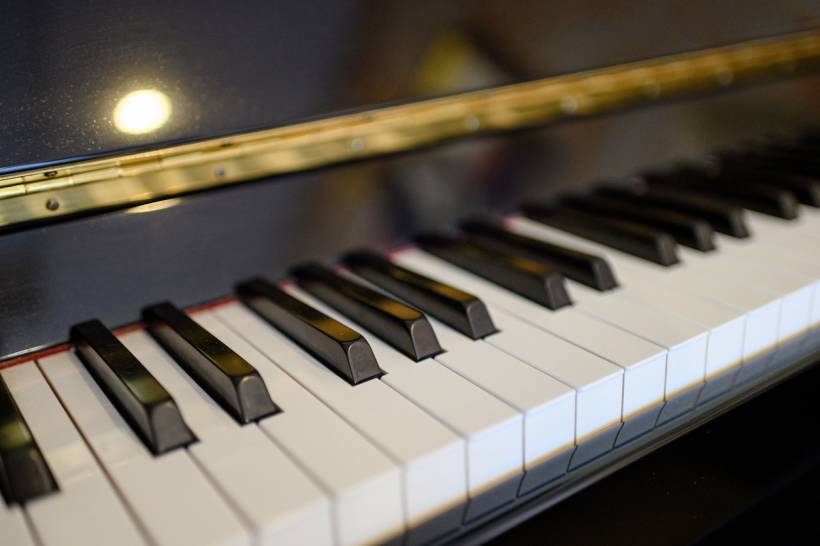 cost to move a piano - Close-up of piano keys with polished black and white finish