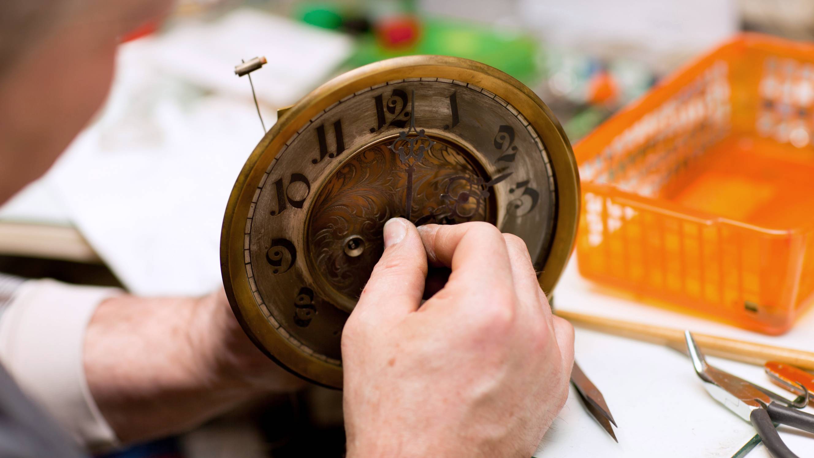 Man repairing an old clock