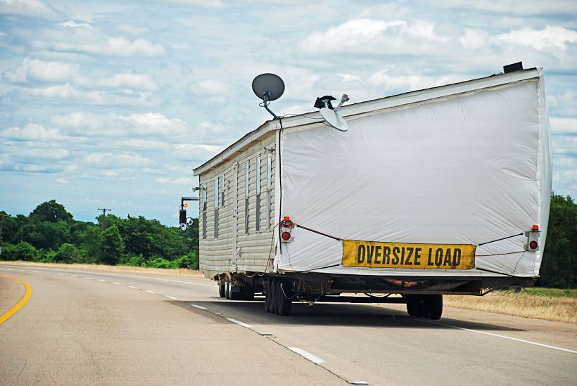 cost to move a shed - Large shed or mobile home wrapped and labeled as oversize load on highway