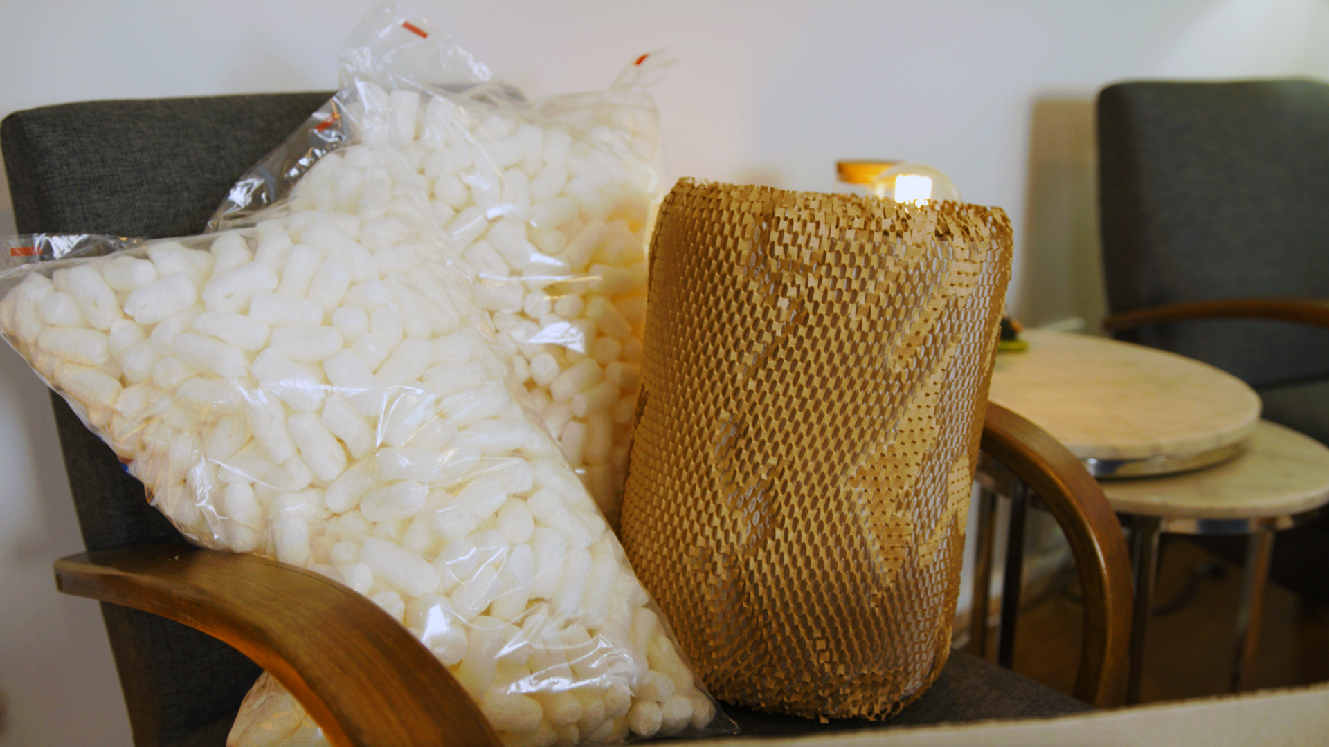 how to pack a moving truck - Close-up of packing supplies when moving, with biodegradable peanuts and wrapping paper
