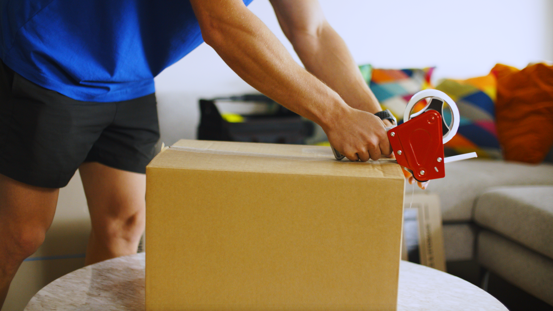 how to pack a moving truck - Tasker sealing a box with tape